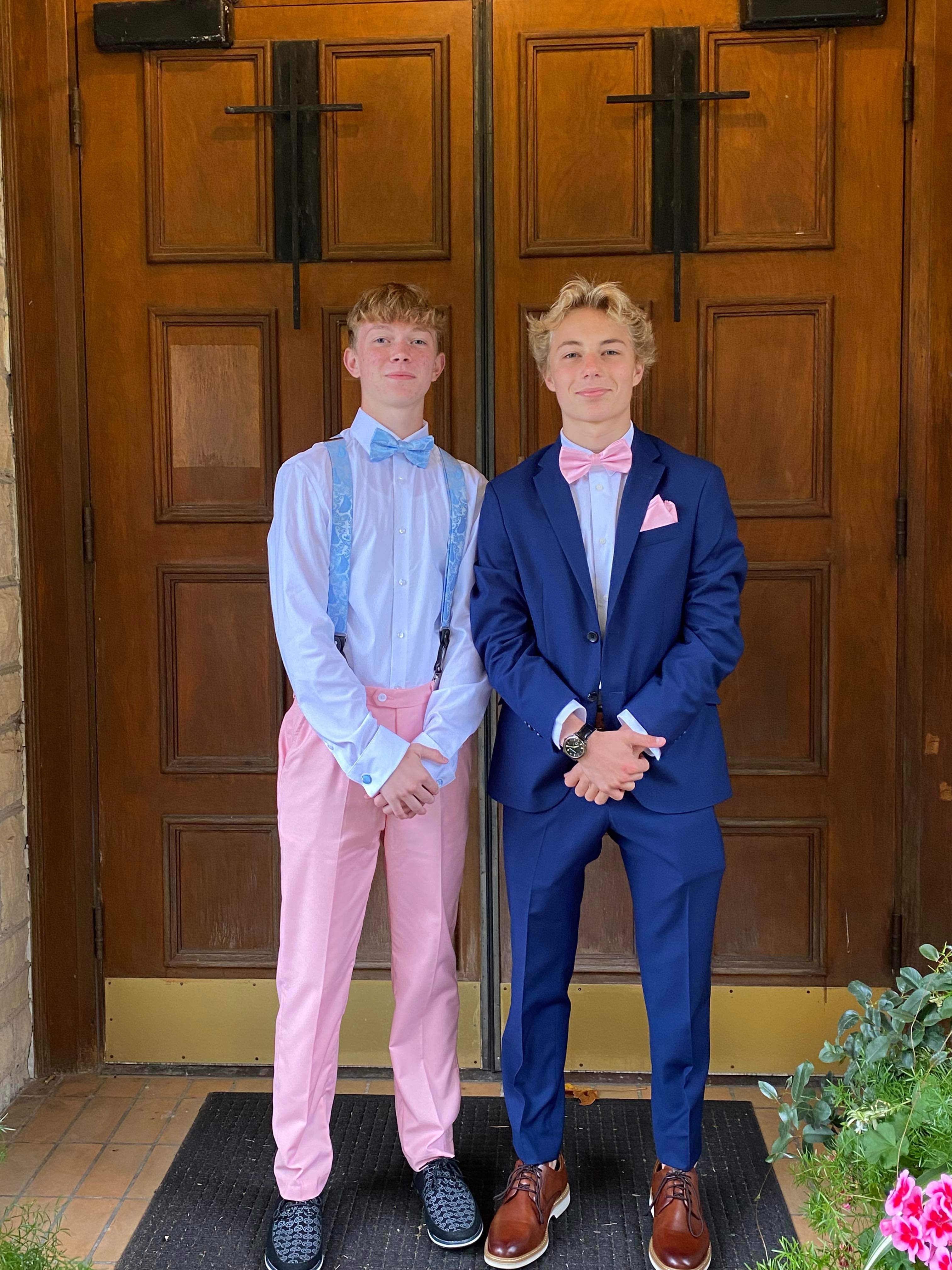 Sam dressed up in front of wooden doors